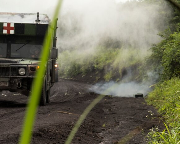 An M997A2 Humvee High Mobility Multipurpose Wheeled Vehicle ambulance gets hit by a simulated Improvised Explosive Device during Exercise Dragon Fire 2014 at Combined Arms Training Center Camp Fuji, Japan, July 19. Dragon Fire is CLC-36’s annual Battle Skills Training exercise that focuses on improving the individual and collective combat skills of CLC-36 service members with an emphasis on weapons familiarization training.