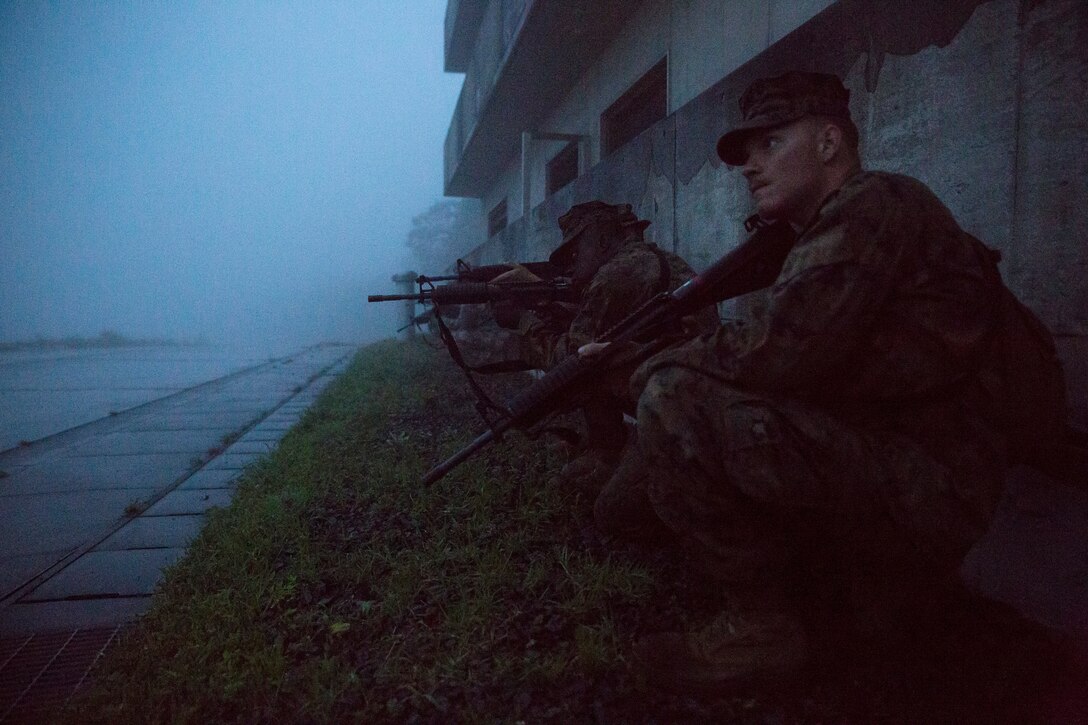 Combat Logistics Company 36 Marines and augments post security during Military Operations on Urban Terrain training as a part of Exercise Dragon Fire 2014 at Combined Arms Training Center Camp Fuji, Japan, July 17. Dragon Fire is CLC-36’s annual Battle Skills Training exercise that focuses on improving the individual and collective combat skills of CLC-36 service members with an emphasis on weapons familiarization training.