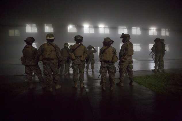 Combat Logistics Company 36 Marines and augments prepare their gear and establish a plan of attack during Military Operations on Urban Terrain training as a part of Exercise Dragon Fire 2014 at Combined Arms Training Center Camp Fuji, Japan, July 17. Dragon Fire is CLC-36’s annual Battle Skills Training exercise that focuses on improving the individual and collective combat skills of CLC-36 service members with an emphasis on weapons familiarization training.
