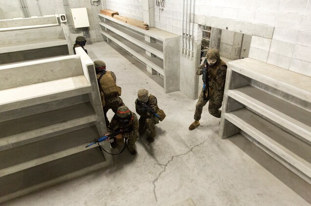 Combat Logistics Company 36 Marines and augments clear a room and post security during Military Operations on Urban Terrain training as a part of Exercise Dragon Fire 2014 at Combined Arms Training Center Camp Fuji, Japan, July 17. Dragon Fire is CLC-36’s annual Battle Skills Training exercise that focuses on improving the individual and collective combat skills of CLC-36 service members with an emphasis on weapons familiarization training.