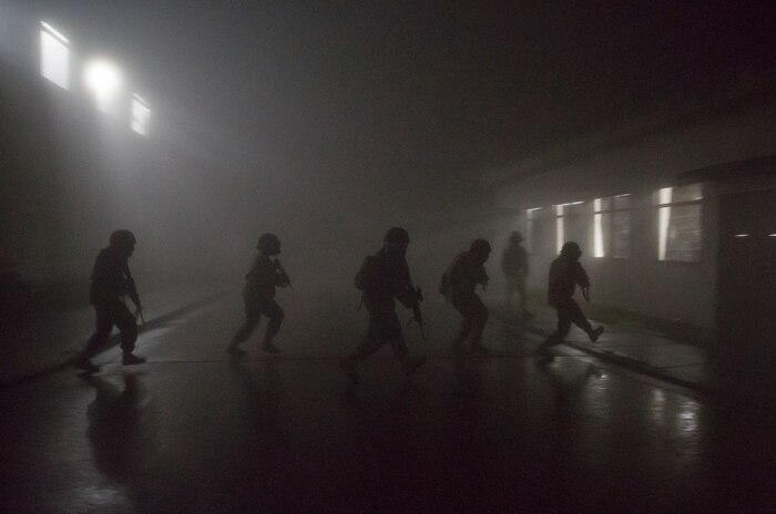 Combat Logistics Company 36 Marines and augments move to an unsecured building during Military Operations on Urban Terrain training as a part of Exercise Dragon Fire 2014 at Combined Arms Training Center Camp Fuji, Japan, July 17. Dragon Fire is CLC-36’s annual Battle Skills Training exercise that focuses on improving the individual and collective combat skills of CLC-36 service members with an emphasis on weapons familiarization training.
