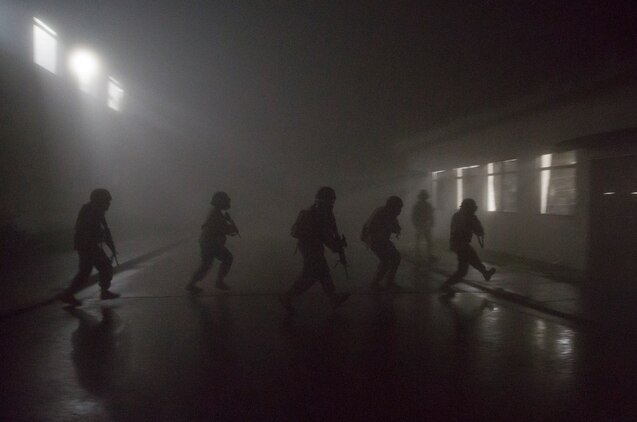 Combat Logistics Company 36 Marines and augments move to an unsecured building during Military Operations on Urban Terrain training as a part of Exercise Dragon Fire 2014 at Combined Arms Training Center Camp Fuji, Japan, July 17. Dragon Fire is CLC-36’s annual Battle Skills Training exercise that focuses on improving the individual and collective combat skills of CLC-36 service members with an emphasis on weapons familiarization training.