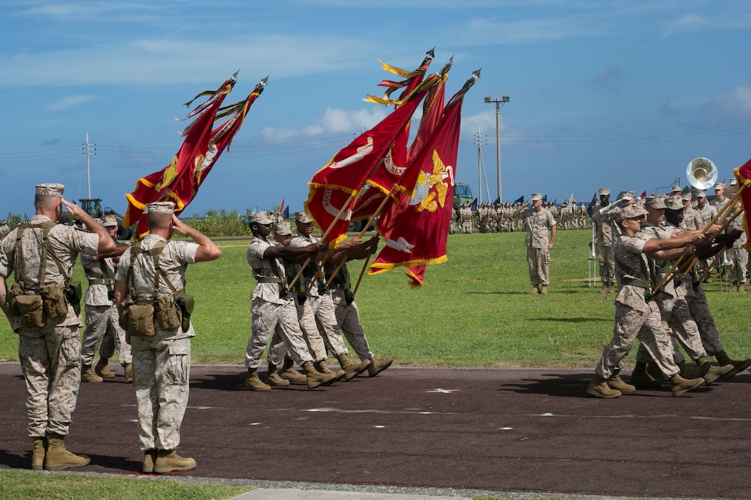 Brig. Gen. Niel E. Nelson, far left, and Brig. Gen. (select) Tracy W. King, second from left, salute the colors of the various units with 3rd Marine Logistics Group, III Marine Expeditionary Force, July 18 during a change of command ceremony at Roberts Field on Camp Kinser. The event marked the end of Nelson’s two-year rotation as commanding general of 3rd Marine Logistics Group, III MEF. King takes command of 3rd MLG following his command of Combat Logistics Regiment 15, 1st MLG, I MEF. “This world-class logistics group has done everything I’ve asked them to do,” said Nelson, a Genoa, Nevada, native. “It’s been my pleasure to come in to work; there’s nothing they can’t do.” King is an Oklahoma City, Oklahoma, native. (U.S. Marine Corps photo by Lance Cpl. Pete Sanders/Released)