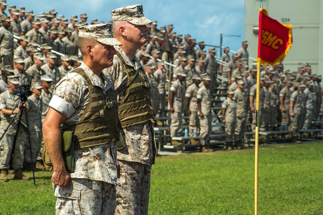 Brig. Gen. Niel E. Nelson, center, and Brig. Gen. (select) Tracy W. King, left, watch as 3rd Marine Logistics Group, III Marine Expeditionary Force, conduct a pass in review July 18 during a change of command ceremony on Roberts Field on Camp Kinser. The event marked the end of Brig. Gen. Niel E. Nelson’s two-year rotation as commanding general of 3rd Marine Logistics Group, III MEF. Brig. Gen. (select) Tracy W. King takes command of 3rd MLG following his command of Combat Logistics Regiment 15, 1st MLG, I MEF. Nelson is a Genoa, Nevada, native, and King is an Oklahoma City, Oklahoma, native. (U.S. Marine Corps photo by Lance Cpl. Pete Sanders/Released)