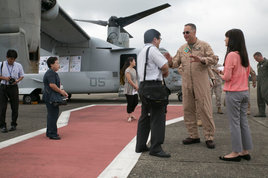 Maj. Gen. Andrew W. O’Donnell, center, talks to a representative of the North Kanto Defense Bureau, left, July 20 during a static display of the MV-22B Osprey tiltrotor aircraft at Yakota Air Base. Marines flew two of their Ospreys to the Sapporo Okadama Airport for the 28th Sapporo Airshow. The Osprey made its debut at the airshow to familiarize the Japanese community with the aircraft. O’Donnell is the deputy commander of U.S. Forces Japan, and the Marines are with Marine Medium Tiltrotor Squadron 262, Marine Aircraft Group 36, 1st Marine Aircraft Wing, III Marine Expeditionary Force. (U.S. Marine Corps Photo by Lance Cpl. Thor J. Larson/ Released)