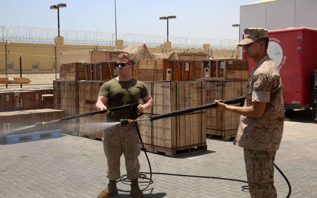 U.S. 5TH FLEET AREA OF RESPONSIBILITY (July 22, 2014)  U.S. Marine Corps Cpls. Dylan Shuler, left, and Gregory Savage, right, chemical, biological, radiological and nuclear defense (CBRN) specialists with the 22nd Marine Expeditionary Unit (MEU), practice using an M26 joint service transportable decontamination system during a CBRN training evolution on Naval Station Bahrain. The 22nd MEU is deployed with the Bataan Amphibious Ready Group as a theater reserve and crisis response force throughout U.S. Central Command and the U.S. 5th Fleet area of responsibility. (U.S. Marine Corps photo by Cpl. Caleb McDonald/Released)