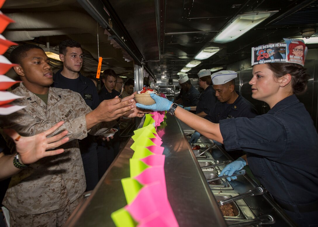 U.S. 5TH FLEET AREA OF RESPONSIBILITY (July 23, 2014) U.S. Navy Sailors aboard the amphibious transport dock ship USS Mesa Verde (LPD 19) serve ice cream to U.S. Marines with the 22nd Marine Expeditionary Unit (MEU) and their fellow Sailors during an ice cream social. The 22nd MEU is deployed with the Bataan Amphibious Ready Group as a theater reserve and crisis response force throughout U.S. Central Command and the U.S. 5th Fleet area of responsibility. (U.S. Marine Corps photo by Cpl. Manuel A. Estrada/Released)