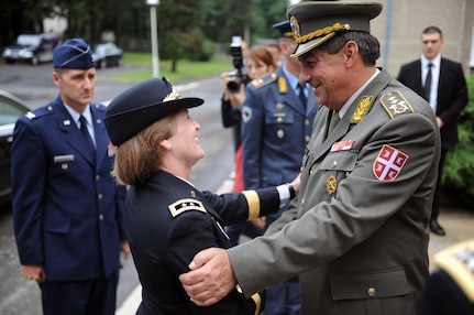 Gen. Ljubisa Dikovic, Serbia's chief of defense, welcomes Army Maj. Gen. Deborah Ashenhurst, adjutant general of the Ohio National Guard, for a meeting in Belgrade, Serbia, July 23, 2014. Serbia and Ohio have been partners in the National Guard State Partnership Program since 2006.