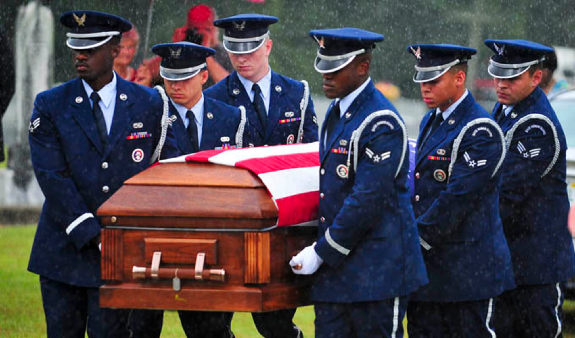 Capt. Robert Turnbull Sr.’s remains are carried by members of the Tyndall Air Force Base Honor Guard during his funeral July 19, 2014, at Barnetts Creek Baptist Church Cemetery, Thomas County, Ga. Trunbull was one of 52 service members lost during a C-124 Globemaster crash in Alaska in 1952. (U.S. Air Force photo/Airman 1st Class Dustin Mullen)
