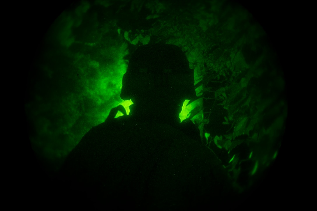 A Marine with Lima Company, Battalion Landing Team 3rd Battalion, 6th Marine Regiment, 24th Marine Expeditionary Unit, provides security during a nighttime raid exercise at Camp Lejeune, N.C., July 27, 2014. Marines with the 24th Marine Expeditionary Unit’s Maritime Raid Force discuss final details for a nighttime raid exercise at Camp Lejeune, N.C., July 27, 2014. The 24th MEU is currently conducting Realistic Urban Training, the unit’s first major pre-deployment exercise in preparation for their deployment at the end of the year. (U.S. Marine Corps photo by Cpl. Todd F. Michalek)