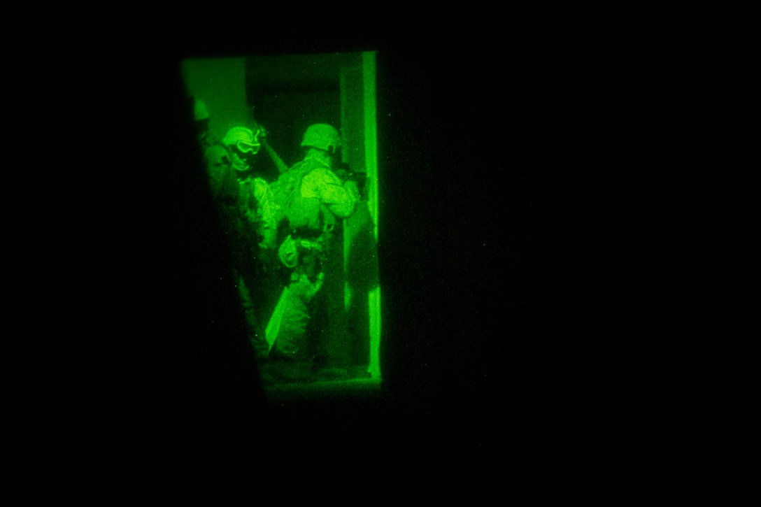 Marines with the 24th Marine Expeditionary Unit’s Maritime Raid Force clear a room during a nighttime raid exercise at Camp Lejeune, N.C., July 27, 2014. The 24th MEU is currently conducting Realistic Urban Training, the unit’s first major pre-deployment exercise in preparation for their deployment at the end of the year. (U.S. Marine Corps photo by Cpl. Todd F. Michalek)