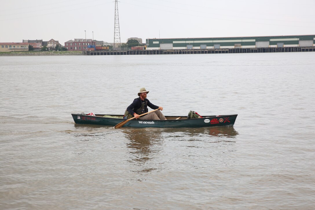 Former Marine Cpl. Joshua Ploetz, makes his way to shore before beaing greeted by a crowd of Marines, sailors, veterans family members  July 25, 2014, as he paddles closer to the end of his 2,575-mile journey down the Mississippi River, in New Orleans, July 25, 2014. Ploetz began his journey to raise awareness for post-traumatic stress May 19, at Lake Itasca Minn.