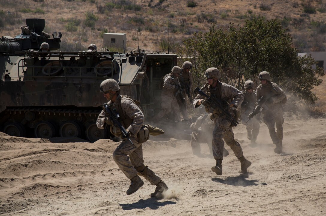 Marines with 14th Marine Regiment, Marine Forces Reserve, exit an Amphibious Assault Vehicle during a live-fire range as a part of the battalion’s annual training exercise here, July 21, 2014. The two week exercise included live-fire tank and infantry integration as well as amphibious operations which gave the Marines a chance to operate in a simulated ship-to-shore movement. (U.S. Marine Corps photo by Cpl. Codey Underwood)