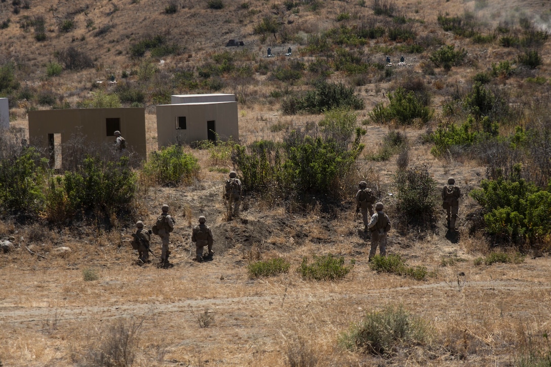 Marines with 14th Marine Regiment, Marine Forces Reserve, maneuver through buildings and rough terrain to reach their targets during a live-fire range as a part of the battalion’s annual training exercise here, July 21, 2014. The two week exercise included live-fire tank and infantry integration as well as amphibious operations which gave the Marines a chance to operate in a simulated ship-to-shore movement. (U.S. Marine Corps photo by Cpl. Codey Underwood)