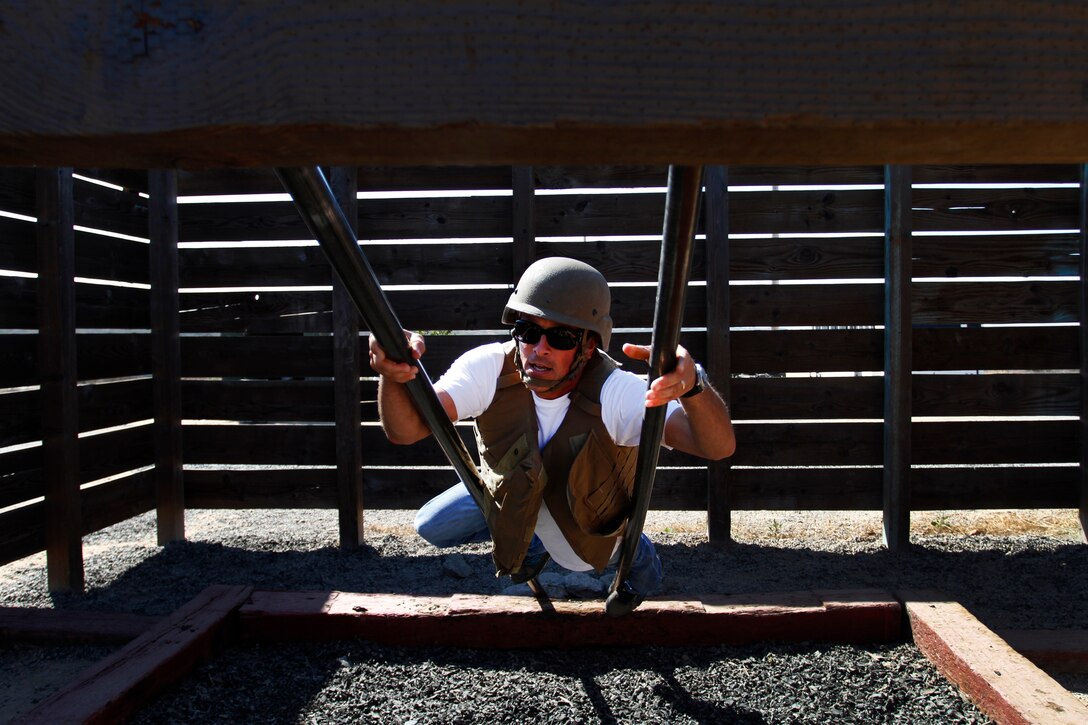 Educators and community influencers from Recruiting Station Salt Lake City and RS San Francisco learn about and get a first-hand experience of Marine Corps recruit training as part of an Educator's Workshop at Marine Corps Recruit Depot San Diego, July 22, 2014. The educators and community leaders are given the chance to learn about the transition from civilian to Marine and what is expected of a Marine on a day-to-day basis to better understand what the Marine Corps can offer for a transitioning young man or woman. (U.S. Marine Corps photo by Sgt. Daniel Wetzel) 
