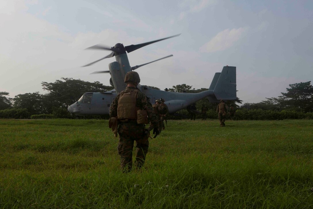Marines and Sailors with Special Purpose Marine Air Ground Task Force South unload their equipment from an MV-22 Osprey at Colombian Marine Corps Base Coveñas, Colombia, July 16, 2014. The Marines exchanged knowledge and tactics with the Colombian Marines through training events and classroom instruction. The SPMAGTF came to Colombia aboard the future amphibious assault ship USS America (LHA 6) during its transit around South America. A SPMAGTF is a balanced air, ground and logistics force that can be tailored to accomplish missions across a wide range of crises. As the first stop on the ship's transit, the visit to Colombia also represents the first time Marines and Sailors have been tactically inserted into an environment from the newly built ship. Through partner-nation activities, key leader engagements and security cooperation activities, the visit aims at further strengthening our partnership in the region, increasing interoperability and building mutual trust between the U.S. and Colombia. (U.S. Marine Corps photo by Cpl. Christopher J. Moore/Released)