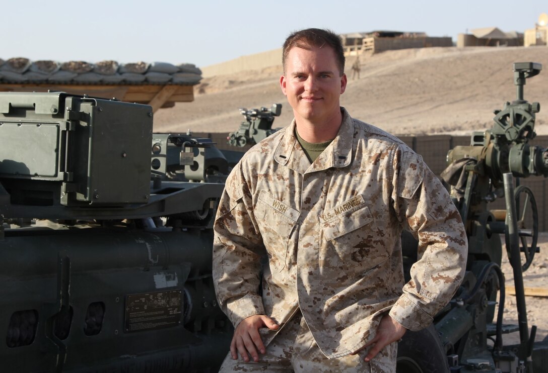 First Lt. Michael Wish, a native of Colorado Springs, Colo., and executive officer of Tango Battery, 5th Battalion, 11th Marine Regiment, poses for a photo next to an M777 Howitzer nicknamed "Death Wish," aboard Camp Bastion, Helmand province, Afghanistan, July 21, 2014. Wish deployed to Helmand during 2012 and served in Now Zad. During his current deployment, Tango Battery has provided additional security for coalition forces during the Helmand drawdown as forces prepare to retrograde and redeploy by the end of 2014.