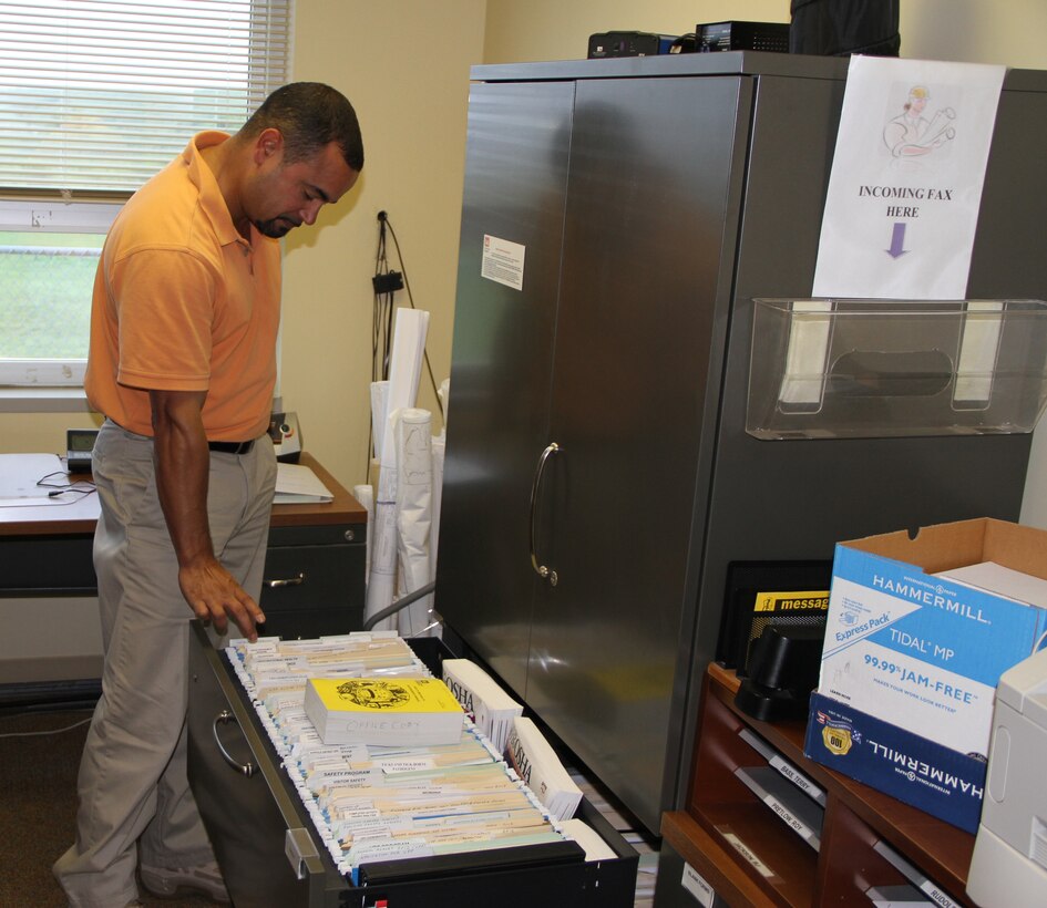 Carlos Quinones, Craney Island acting chief, points to the site’s contrasting safety and health management files before and after they earned their VPP Star status.