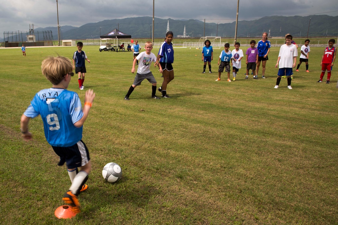 Participants of the Southern California Seahorse Soccer Club soccer camp take part in a scrimmage at Penny Lake fields aboard Marine Corps Air Station Iwakuni, July 24, 2014. The soccer camp was hosted by the Seahorses in association with Marine Corps Community Services to provide Iwakuni youth the opportunity to improve their soccer skills.