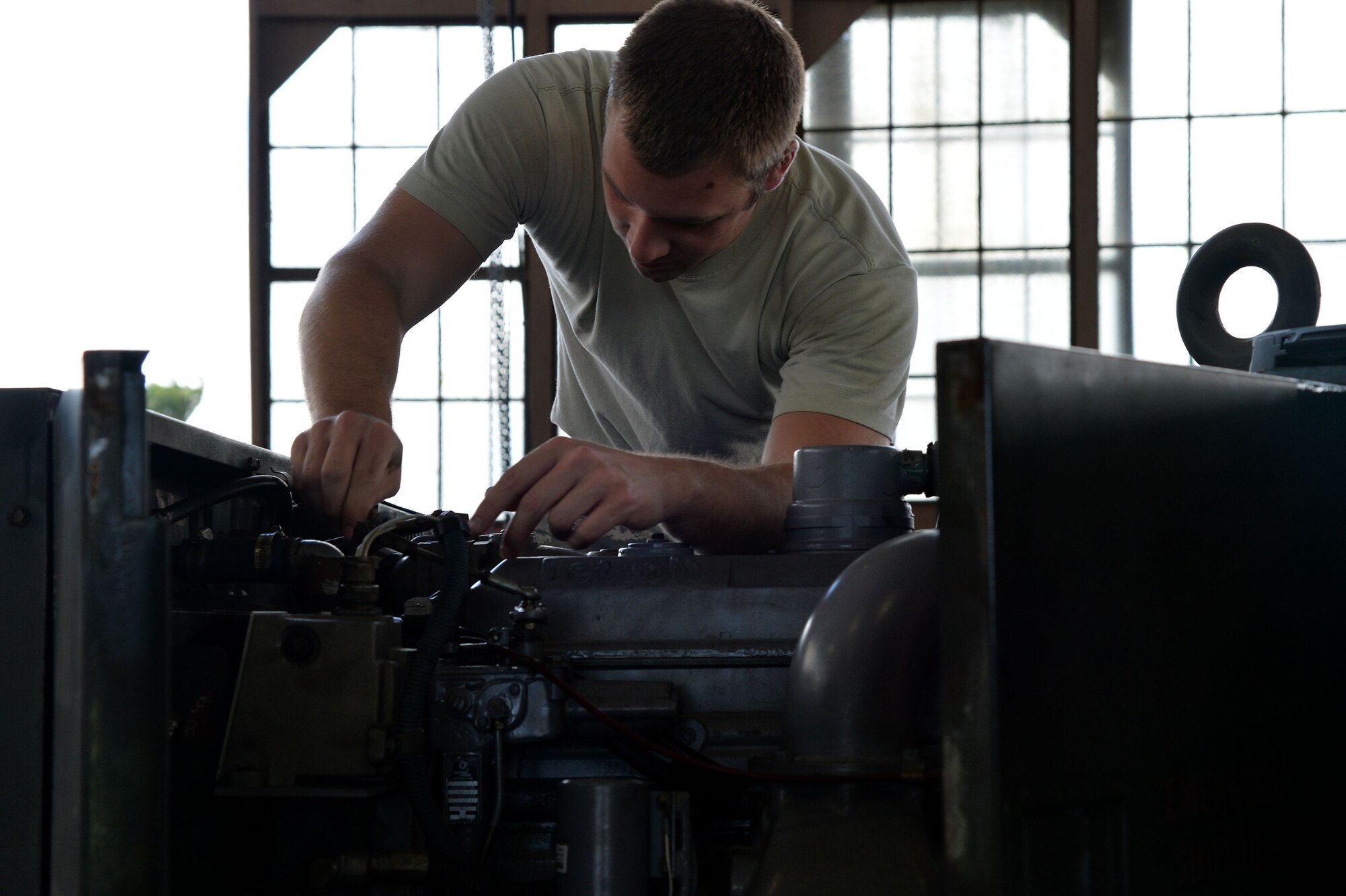 Staff Sgt. Joel Morris, 15th Maintenance Squadron C-17 Globemaster Aerospace Ground Equipment, put final touches on a newly repaired power cart generator at Joint Base Pearl Harbor-Hickam, Hawaii, July 28, 2014. Morris and the rest of the AGE flight have been working hard to ensure their aircraft, as well as visiting aircraft for Rim of the Pacific 2014, have what they need while on the ground. RIMPAC is the world's largest maritime exercise, and comprises 22 nations operating around the Hawaiian Islands and Southern California to foster and sustain cooperative relationships that are critical to ensuring the safety of sea lanes and security on the world's oceans. (U.S. Air Force photo by Staff Sgt. Alexander Martinez)