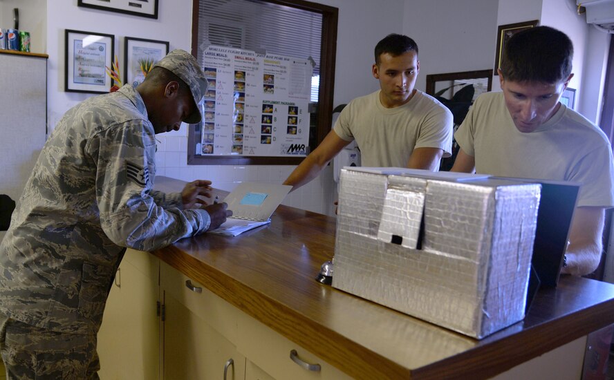 Staff Sgt. Corey Pitts, 647th Force Support Squadron, takes lunch orders at the flight kitchen at Joint Base Pearl Harbor-Hickam, Hawaii, July 25, 2014. The flight kitchen has kept busy with the influx of personnel here for Rim of the Pacific 2014. RIMPAC is the world's largest maritime exercise, and comprises 22 nations operating around the Hawaiian Islands and Southern California to foster and sustain cooperative relationships that are critical to ensuring the safety of sea lanes and security on the world's oceans. (U.S. Air Force photo by Staff Sgt. Alexander Martinez)
