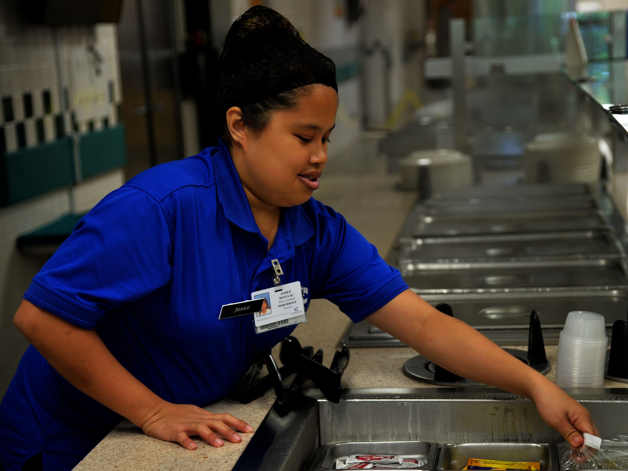 Janice Matulac, Hale Aina Dining Facility staff member, prepares a sandwich bar for lunch at Joint Base Pearl Harbor-Hickam, Hawaii, July 25, 2014. In addition to their regular operations, the DFAC staff supports the influx of personnel here for Rim of the Pacific 2014. RIMPAC is the world's largest maritime exercise, and comprises 22 nations operating around the Hawaiian Islands and Southern California to foster and sustain cooperative relationships that are critical to ensuring the safety of sea lanes and security on the world's oceans. (U.S. Air Force photo by Staff Sgt. Alexander Martinez)
