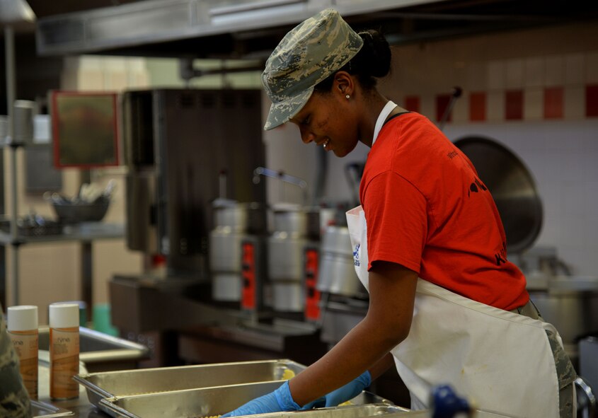 Airman 1st Class Jaleesa Randle, 647th Force Support Squadron, prepares lasagna for lunch at the Hale Aina Dining Facility at Joint Base Pearl Harbor-Hickam, Hawaii, July 25, 2014. In addition to their regular operations, Randle and the DFAC staff support the influx of personnel here for Rim of the Pacific 2014. RIMPAC is the world's largest maritime exercise, and comprises 22 nations operating around the Hawaiian Islands and Southern California to foster and sustain cooperative relationships that are critical to ensuring the safety of sea lanes and security on the world's oceans. (U.S. Air Force photo by Staff Sgt. Alexander Martinez)