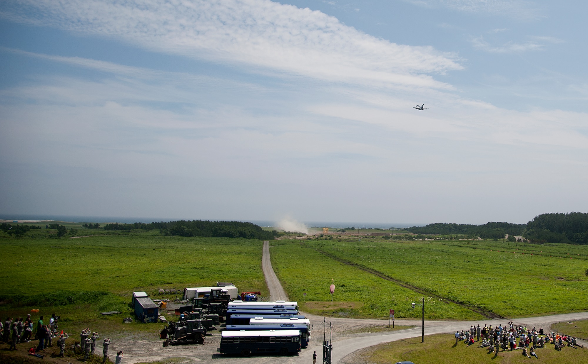 An F-16 Fighting Falcon from Misawa Air Base, Japan, flies over 35th Fighter Wing family members at Draughon Range, Japan, July 18, 2014. The event was hosted by the 35 OG to show more than 375 attendees the capabilities of the U.S. Air Force, as well as the precision of its pilots. (U.S. Air Force photo/ Staff Sgt. Tong Duong)