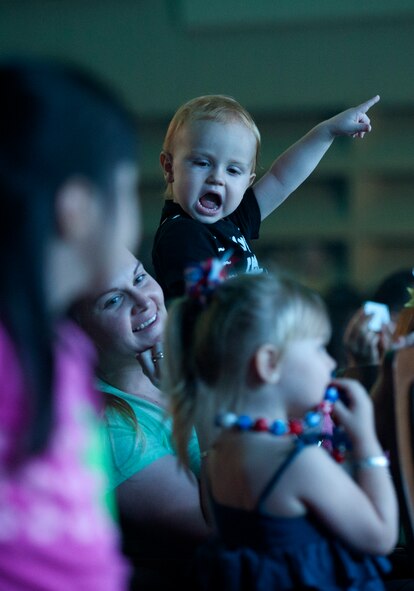 Misawa Air Base family members enjoy a show by TOPS IN BLUE performers at the Misawa Civic Center in Misawa, Japan, July 25, 2014. The 35-member team performed an energetic, choreographed show, featuring many popular songs from throughout the years. (U.S. Air Force photo/ Staff Sgt. Tong Duong) 