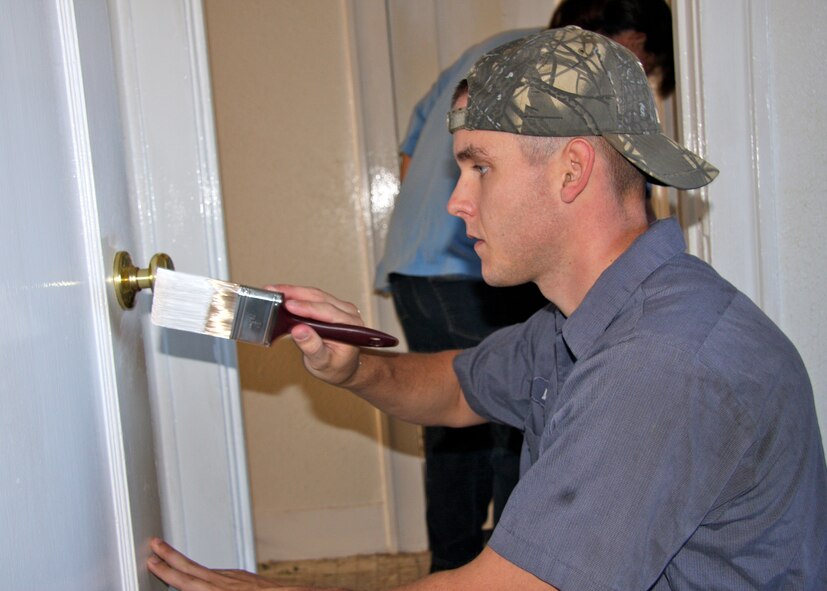 U.S. Air Force Airman 1st Class Miles Hambly, 7th Civil Engineer Squadron, paints a door while volunteering for the Dyess We Care Team (WCT). The Dyess WCT is a non-Department of Defense affiliated tax exempt organization that provides minor home repairs to the elderly, disabled and others in need. They also assist with other community oriented non-profit groups like the Boys and Girls Club, New Beginnings, Taylor Jones Humane Society and more. (Courtesy photo)