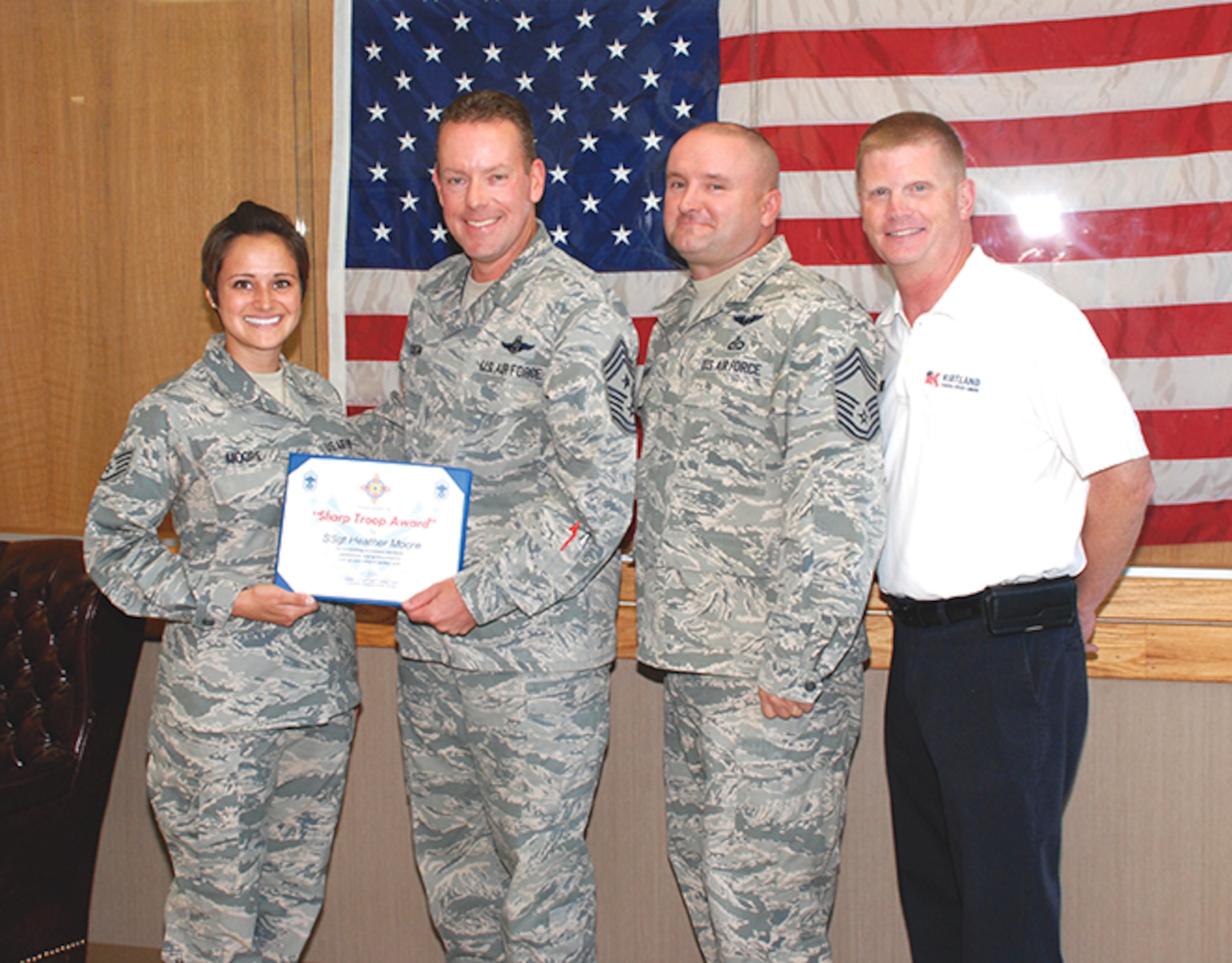 The Kirtland Chiefs’ Group recognized Staff Sgt. Heather Moore, left, of the 58th Special Operations Wing, as the Sharp Troop for June. Moore was recognized for her outstanding professionalism and dedication to the unit. (Photo by Ken Moore)