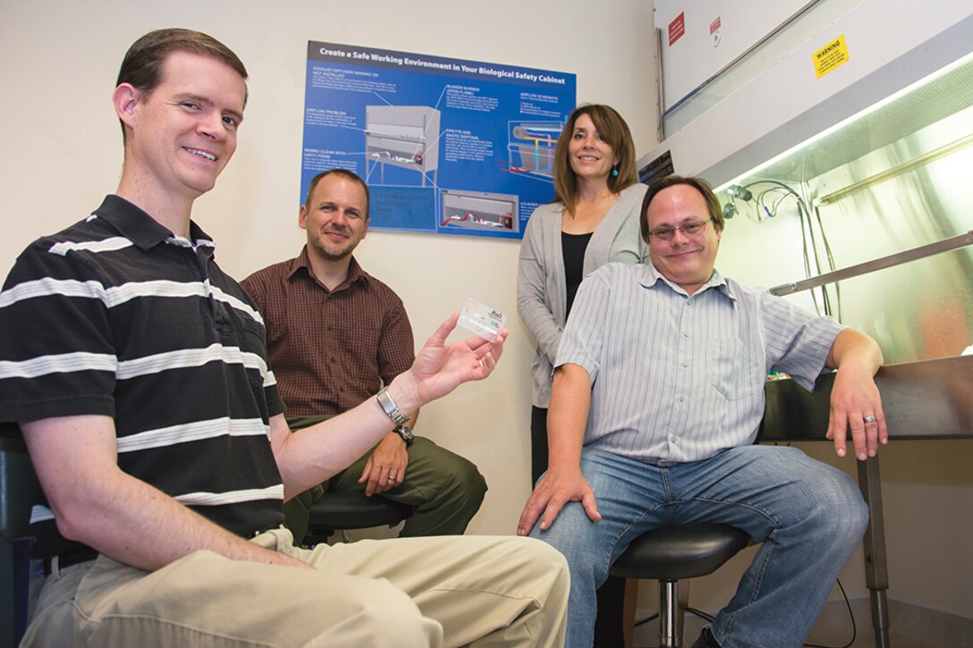 From left, Sandia National Laboratories team members Jason Harper, George Bachand, Melissa Finley and Bryan Carson. The group led invention of the anthrax detector held by Harper, which won an innovation award. (Courtesy photo)