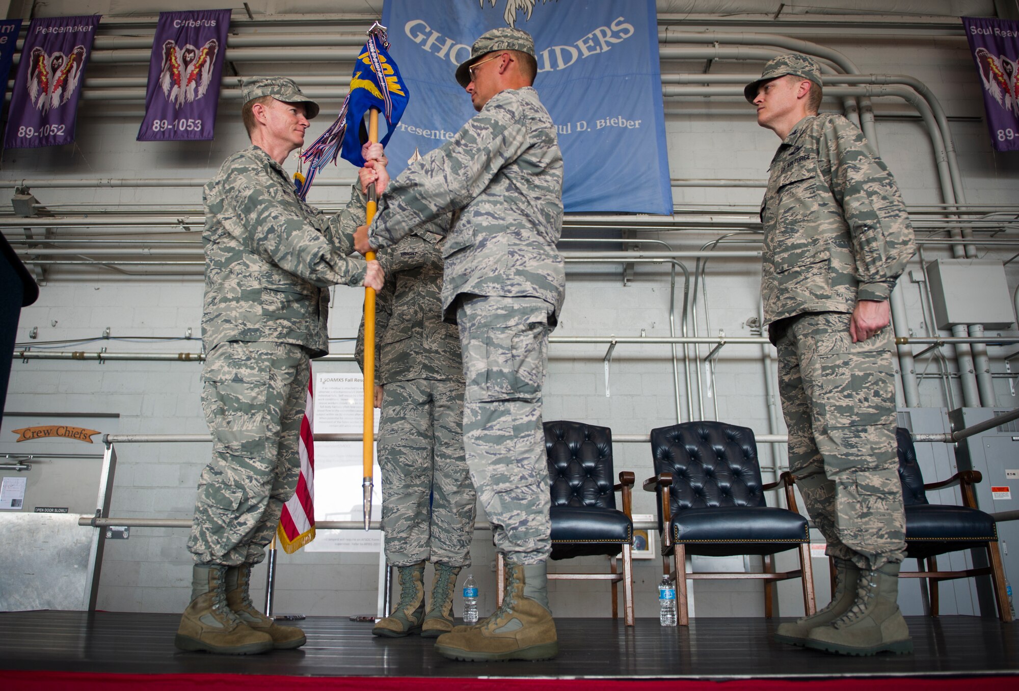 Col. Bill West, 1st Special Operations Wing commander, receives the guidon from Col. Douglas Dudley, outgoing 1st Special Operations Mission Support Group commander, during a ceremony on Hurlburt Field, Fla., July 28, 2014. The Airmen of the 1st SOMSG provide garrison and deployed support for the 1st Special Operations Wing, Air Force Special Operations Command headquarters and 34 partner units.  (U.S. Air Force photo/Senior Airman Christopher Callaway) 