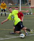John Krafchuk, Hurlburt Field Intramural Soccer Tournament Semifinals left forward, attempts to dribble the ball past an 823rd RED HORSE team member during the Hurlburt Field Intramural Soccer Tournament Semifinals at the Aderholt Fitness Center on Hurlburt Field, Fla., July 25, 2014. More than 10 teams competed in the tournament. (U.S. Air Force photo/Senior Airman Kentavist P. Brackin) 