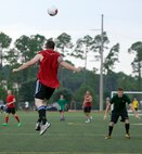 Jeremiah Holt, 823rd RED HORSE midfielder, head butts a soccer ball during the Hurlburt Field Intramural Soccer Tournament Semifinals at the Aderholt Fitness Center on Hurlburt Field, Fla., July 25, 2014. The RED HORSE made it to the semifinals undefeated before losing their first game to the 1st Special Operations Component Maintenance Squadron/4th Aircraft Maintenance Unit team. (U.S. Air Force photo/Senior Airman Kentavist P. Brackin)