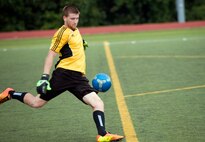 Collin Townsend, 1st Special Operations Component Maintenance Squadron/4th Aircraft Maintenance Unit goalie, delivers a swift goal kick during the semifinals at the Hurlburt Field Intramural Soccer Tournament Semifinals at the Aderholt Fitness Center on Hurlburt Field, Fla., July 25, 2014. Townsend’s team is composed of base personnel from the 1st SOCMS and 4th AMU. (U.S. Air Force photo/Senior Airman Kentavist P. Brackin)