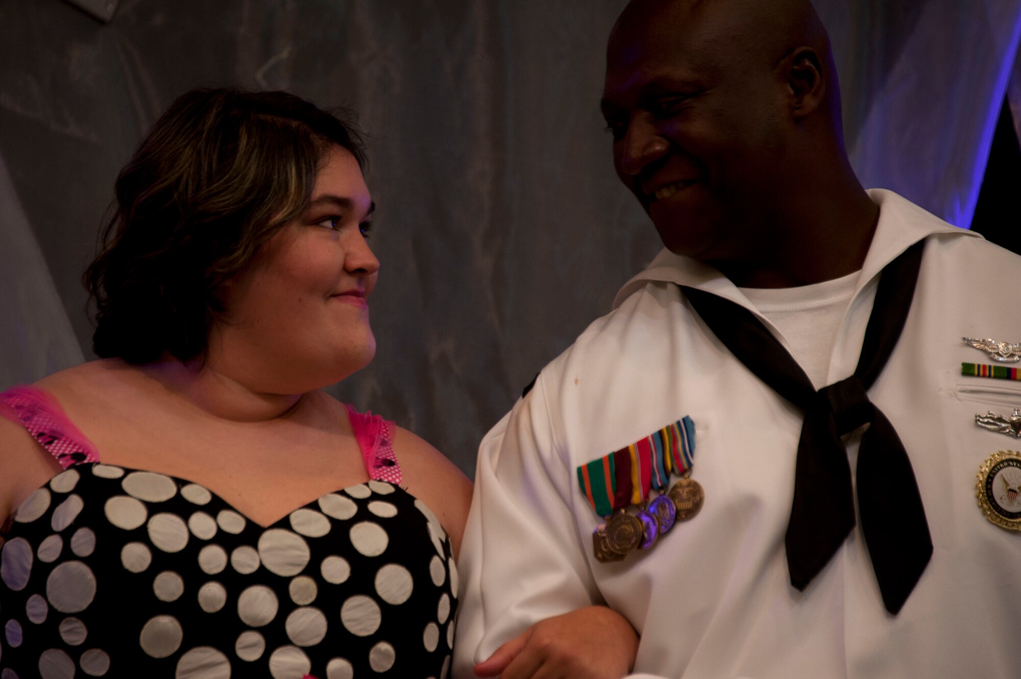 Samantha Brasher looks to Petty Officer 1st Class Demetrius Wimberly, a military volunteer, at the Alabama Angels Pageant July 26, 2014. The pageant recognizes special needs people of all ages for their abilities rather than disabilities. Each participant is crowned with a title reflecting something unique about them. Brasher was crowned, “Miss Ambassador of Angels.” (U.S. Air Force photo by Staff Sgt. Natasha Stannard)