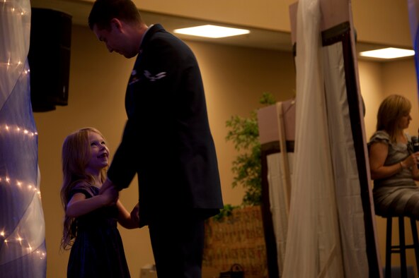 Airman 1st Class Steven Pippin, a military volunteer from Maxwell Air Force Base, dances with a pageant participant at the Alabama Angels Pageant July 26, 2014. The pageant recognizes special needs people of all ages for their abilities rather than disabilities. Each participant is crowned with a title reflecting something unique about them. (U.S. Air Force photo by Staff Sgt. Natasha Stannard)