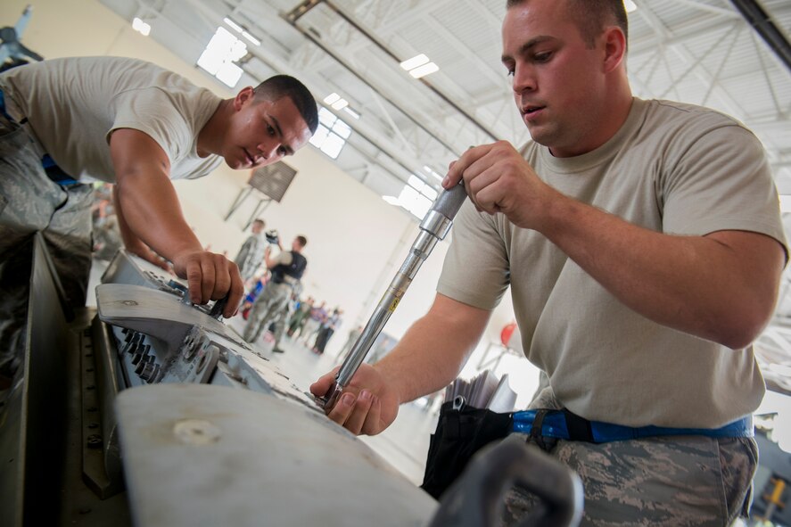 U.S. Air Force Staff Sgt. Christopher Tarbart, right, and Airman 1st Class Xavier Guare, both 74th Aircraft Maintenance Unit load crew members, prepare an AGM-65 Maverick air-to-surface missile for transport during a weapons load competition July 25, 2014, at Moody Air Force Base, Ga. Aside from being named the best load crew of the quarter, the crew showcased the 23d Wing's mission capabilities, while putting on a show for dozens of co-workers and guests. (U.S. Air Force photo by Staff Sgt. Jamal D. Sutter/Released)