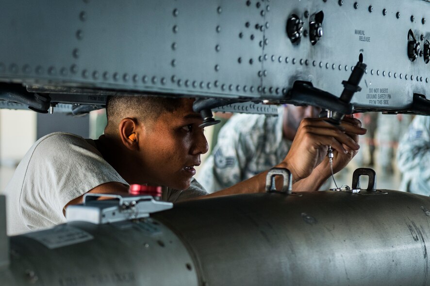 U.S. Air Force Tech. Sgt. Samuel Alonzo, 75th Aircraft Maintenance Unit load crew member, attaches a GBU-38 joint direct attack munition to an A-10C Thunderbolt II during a weapons load competition at Moody Air Force Base, Ga., July 25, 2014. Each crew starts with 1,500 points divided among four categories: 800 for loading, 300 for a written test, 300 for a tool box inspection and 100 for a dress and appearance inspection. Points are deducted for infractions within a respective category. (U.S. Air Force photo by Airman 1st Class Ryan Callaghan/Released)