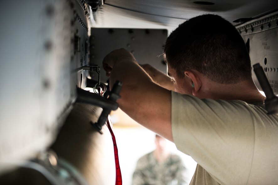 U.S. Air Force Staff Sgt. Benjamin Kaiser, 75th Aircraft Maintenance Unit load crew member, double-checks connections between a GBU-38 joint direct attack munition (JDAM) and an A-10C Thunderbolt II during a weapons load competition at Moody Air Force Base, Ga., July 25, 2014. In addition to the JDAM, Kaiser’s team also loaded an AGM-65 Maverick missile and an AIM-9 Sidewinder missile. (U.S. Air Force photo by Airman 1st Class Ryan Callaghan/Released)
