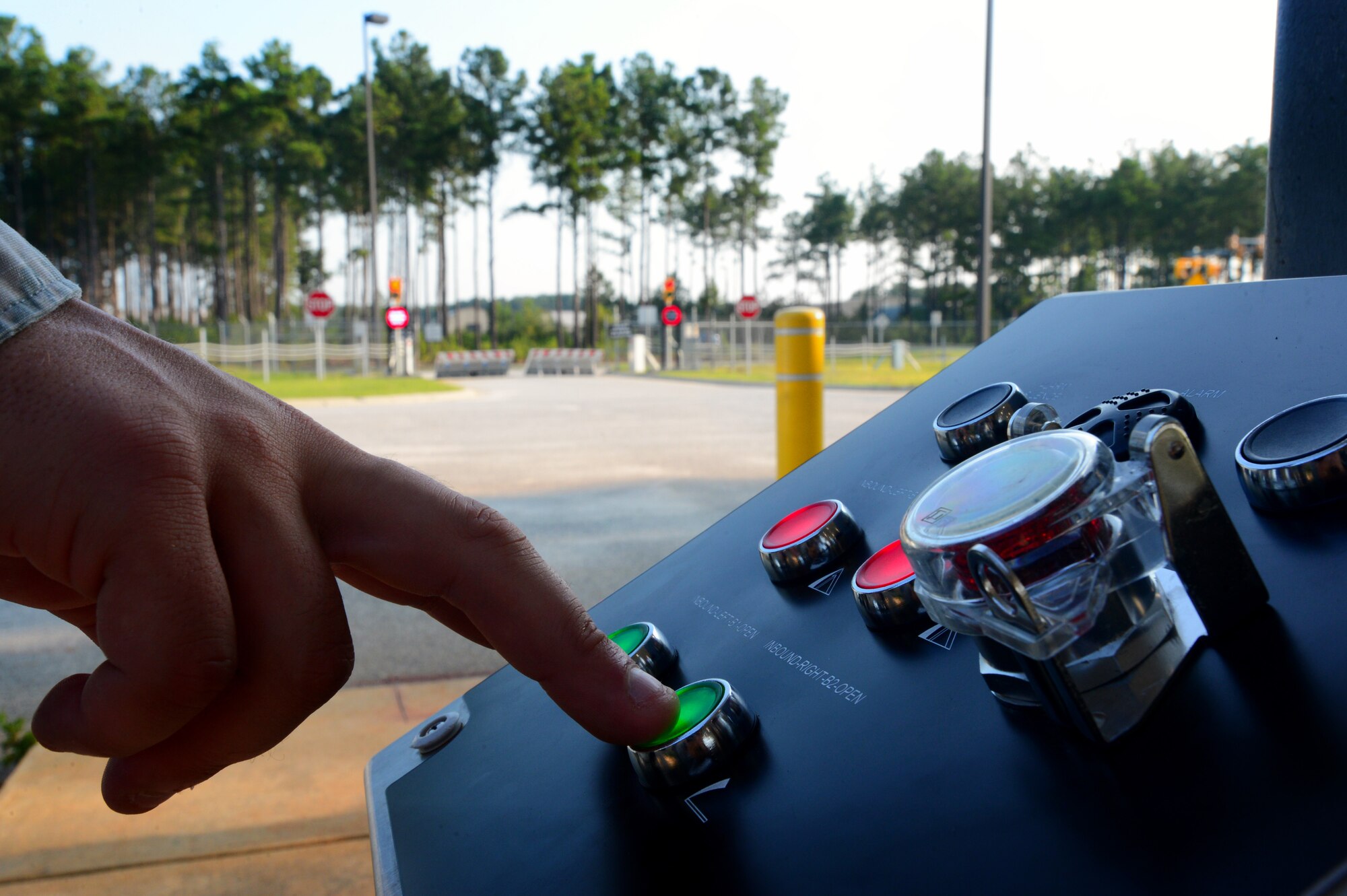 A 20th Security Forces Squadron installation entry control Airman activates barriers via a control panel at the commercial vehicle inspection area at Shaw Air Force Base, S.C., July 24, 2014. The two barriers, which can stop a several-ton semi-truck, control entry to the base by rising up and down at the control of the operator. (U.S. Air Force photo by Airman 1st Class Jensen Stidham/Released) 