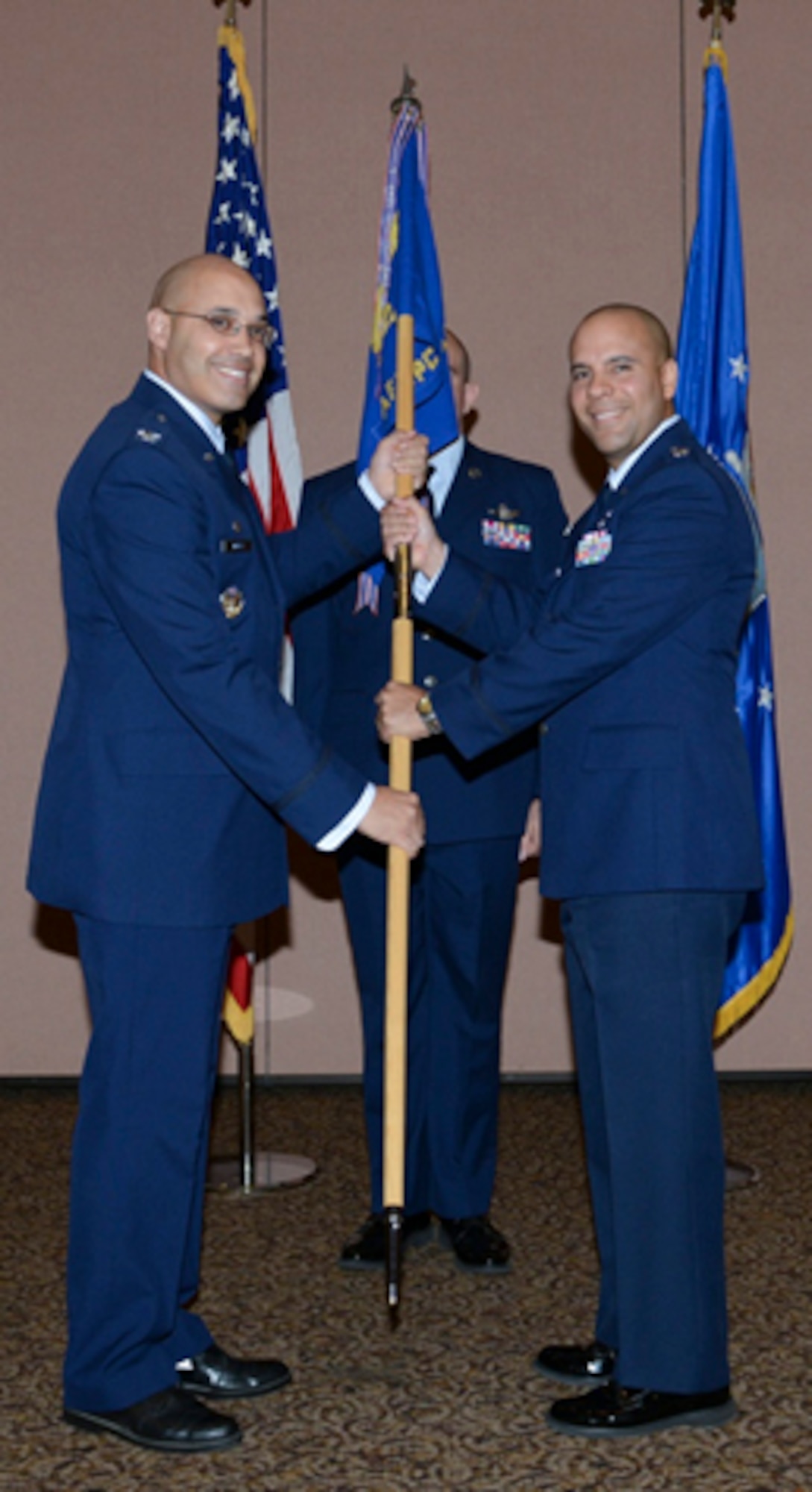 BEALE AIR FORCE BASE, Calif. – Col. David Miller Jr., 21st Operations Group commander, passes the 7th Space Warning Squadron guidon to Lt. Col. Miguel Cruz during the 7th SWS change of command ceremony here June 14. Cruz assumed command from Lt. Col. Mark J. Sorapuru. The 7th SWS is responsible for detecting and reporting missile launches originating from or advancing towards the North American West Coast. The unit also tracks on-orbit spacecraft and provides mid-course interception data in support of United States Strategic Command, the Joint Space Operations Center, and the Missile Defense Agency. (U.S. Air Force photo)
