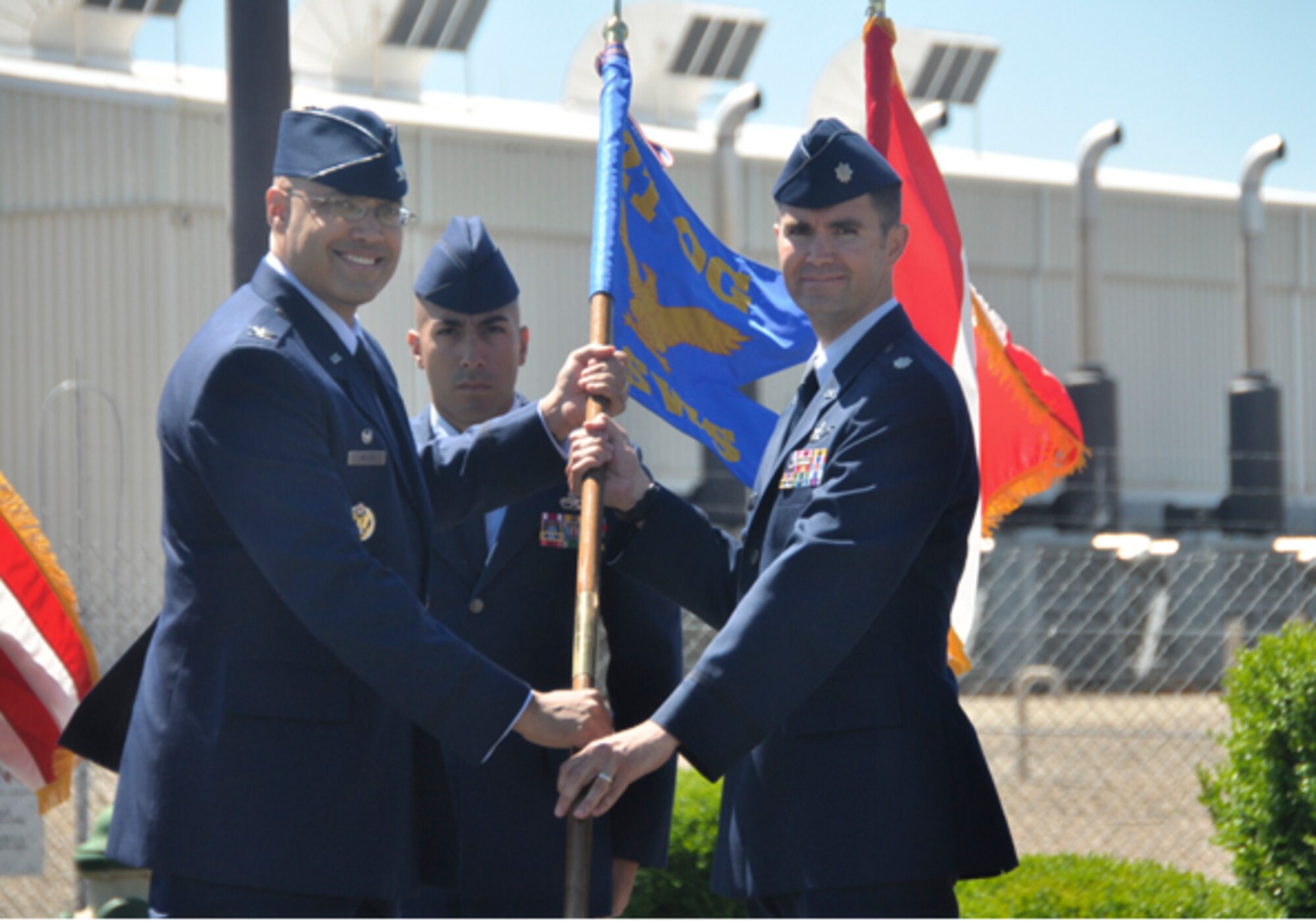CAPE COD AIR FORCE STATION, Mass. – Col. David Miller Jr., 21st Operations Group commander, passes the 6th Space Warning Squadron guidon to Lt. Col. David Anderson during the 6th SWS change of command ceremony June 27 here. Anderson assumed command from Lt. Col. Walt Jackim. The 6th SWS is responsible for detecting and reporting missile launches originating from or advancing towards the North American East Coast. The unit also tracks on-orbit spacecraft and forwards the data to the Joint Space Operations Center to update the consolidated satellite catalogue. (U.S. Air Force photo)