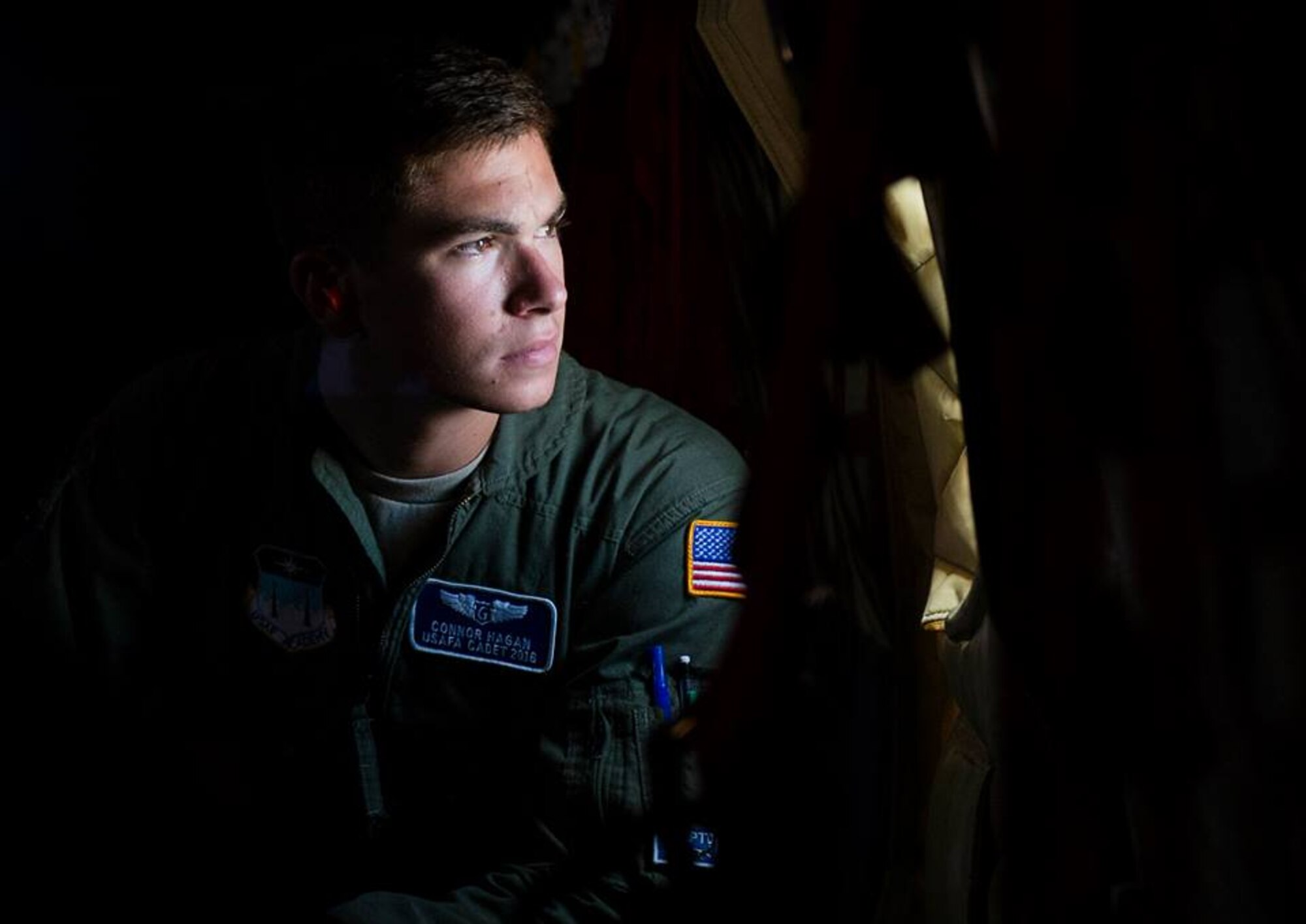 U.S. Air Force Academy Cadet Conner Hagan looks out the window of a KC-135 Stratotanker from the 96th Air Refueling Wing, as it flies over Hawaii during the Rim of the Pacific exercise July 18, 2014. Twenty-two nations, more than 40 ships, six submarines, and more than 200 aircraft and 25,000 personnel will participate in the biennial Rim of the Pacific (RIMPAC) exercise 2014 scheduled June 26 to Aug. 1, in and around the Hawaiian Islands and Southern California. The world's largest international maritime exercise, RIMPAC provides a unique training opportunity that helps participants foster and sustain cooperative relationships that are critical to ensuring the safety of sea lanes and security on the world's oceans. RIMPAC 2014 is the 24th exercise in the series that began in 1971. (U.S. Air Force photo by Senior Airman James Richardson)