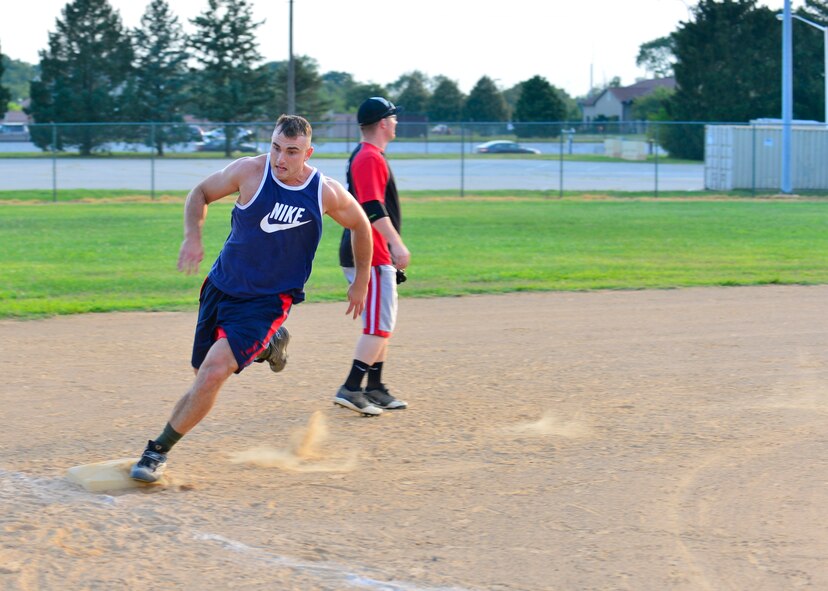 Caleb McGlone, 436th Maintenance Squadron third baseman, rounds third base during an intramural softball game July 23, 2014, at the softball field on Dover Air Force Base, Del. McClone scored three runs in his team’s 13-11 victory against the 436th Maintenance Squadron. (U.S. Air Force photo/Airman 1st Class William Johnson)
