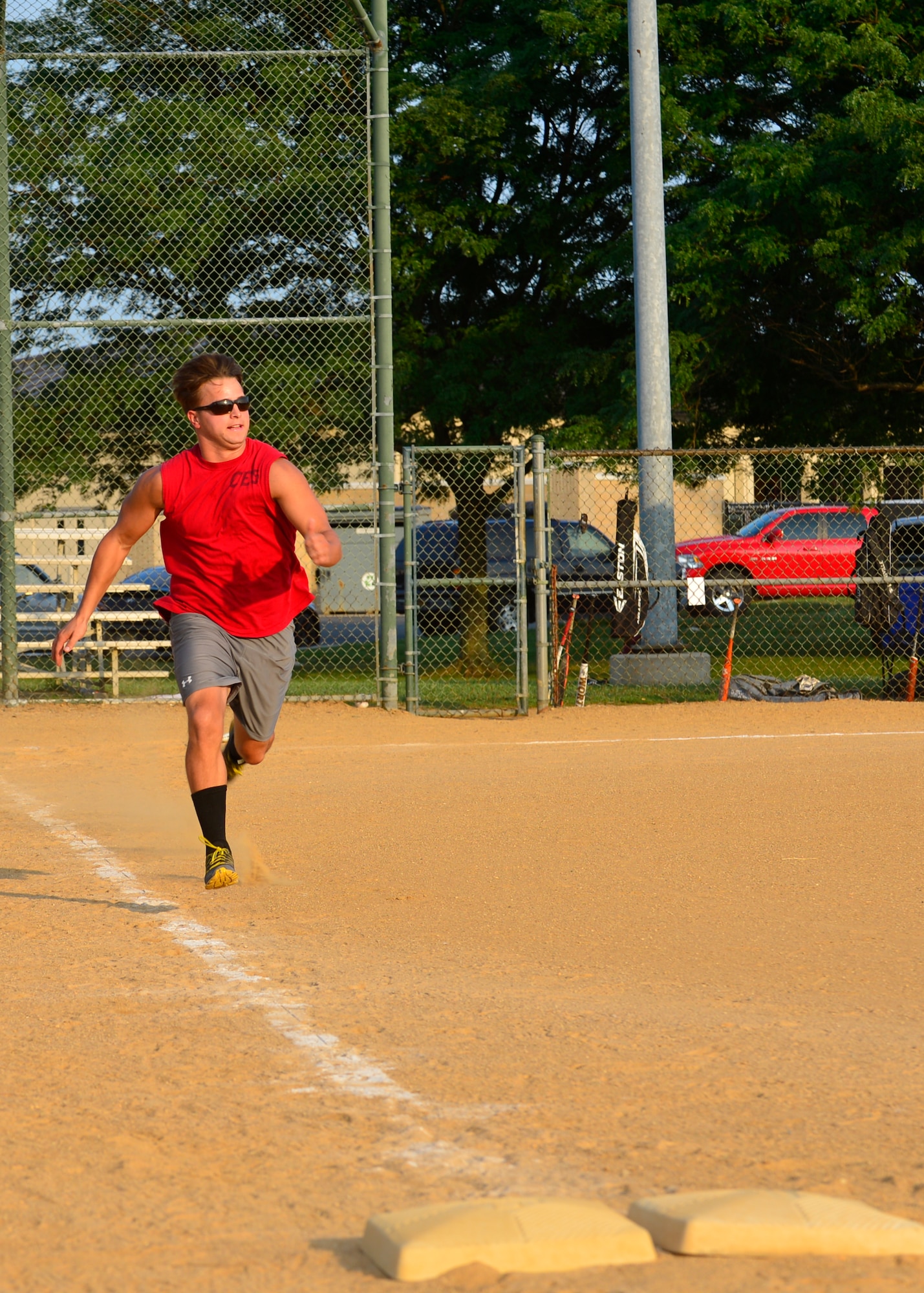 Brook “El Diablo” Morris, 436th Civil Engineer Squadron left fielder, sprints down the first base line during an intramural softball game July 23, 2014, at the field on Dover Air Force Base, Del. The 436th Maintenance Squadron defeated the 436th CES 13-11. (U.S. Air Force photo/Airman 1st Class William Johnson)