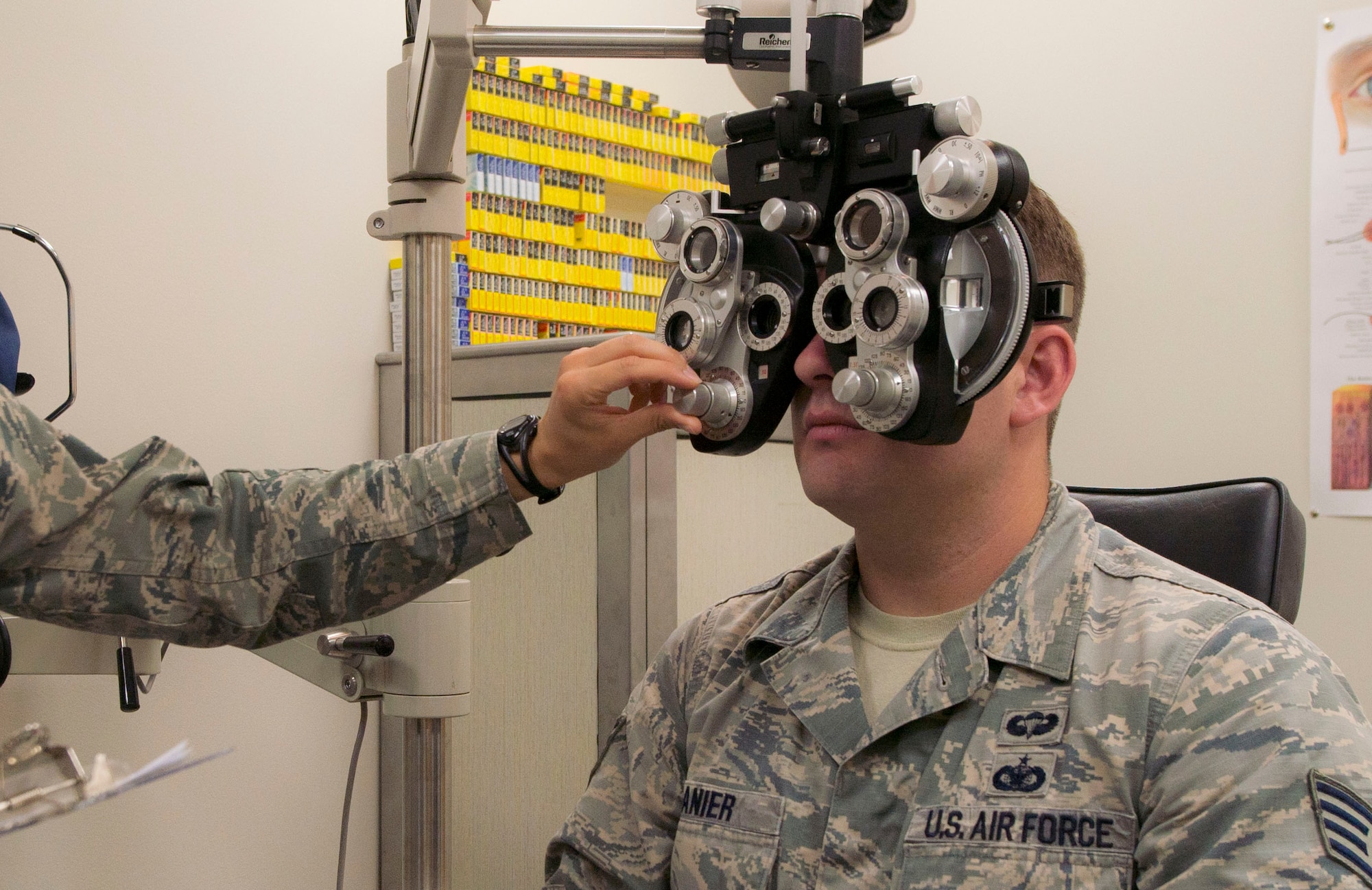 U.S. Air Force Staff Sgt. Chris Ganier, 823d Base Defense Squadron fire team member, receives a routine check-up at the optometry clinic at Moody Air Force Base, Ga., July 25, 2014. Capt. (Dr.) Kaylaen Dittmer, 23d Medical Group optometry specialist, used a phoropter to test Ganier’s different lens prescriptions for each eye. (U.S. Air Force photo by Airman 1st Class  Dillian Bamman /Released)