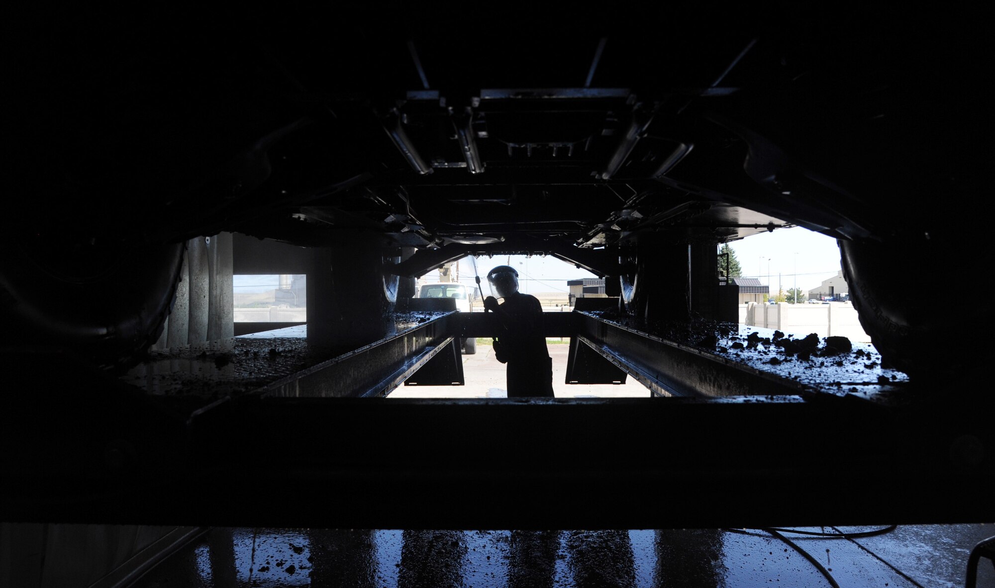 Airman 1st Class Jeremy McNeal, 341st Logistics Readiness Squadron vehicle maintenance apprentice, pressure washes a security forces Humvee July 23. Not every vehicle they receive is clean. The maintenance shop pressure washes every vehicle that comes through. (U.S. Air Force photo/Airman 1st Class Joshua Smoot)