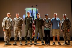 Colonel Jimmy Canlas, 437th Airlift Wing vice commander (left) and Chief Master Sgt. Shawn Hughes, 437th AW command chief (right), congratulate (left to right) Master Sgt. Adam Morgan, Senior Noncommissioned Officer in Charge of the Quarter, Airman 1st Class Stephanie Lucas, Airmen of the Quarter, Staff Sgt. Tyler Wehrung, Noncommissioned Officer in Charge of the Quarter, Faye Ellison, Civilian Category I of the Quarter and Vincent Moseley, Civilian Category II of the Quarter July 24, 2014, during the 437th AW Quarterly Awards ceremony at the Air Base Theater on Joint Base Charleston, S.C. Capt Daniel Naske, Company Grade Officer of the Quarter was unable to attend the ceremony. (U.S. Air Force photo/ Senior Airman Dennis Sloan)